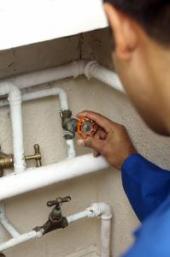 One of our Modesto plumbers associate checks a faulty valve